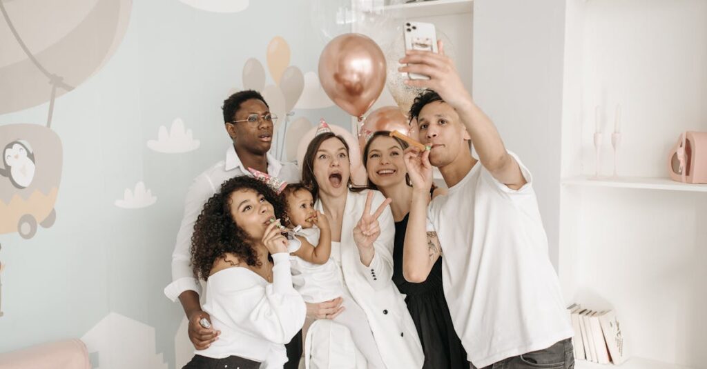 A diverse group of friends take a joyful selfie at a birthday celebration indoors.